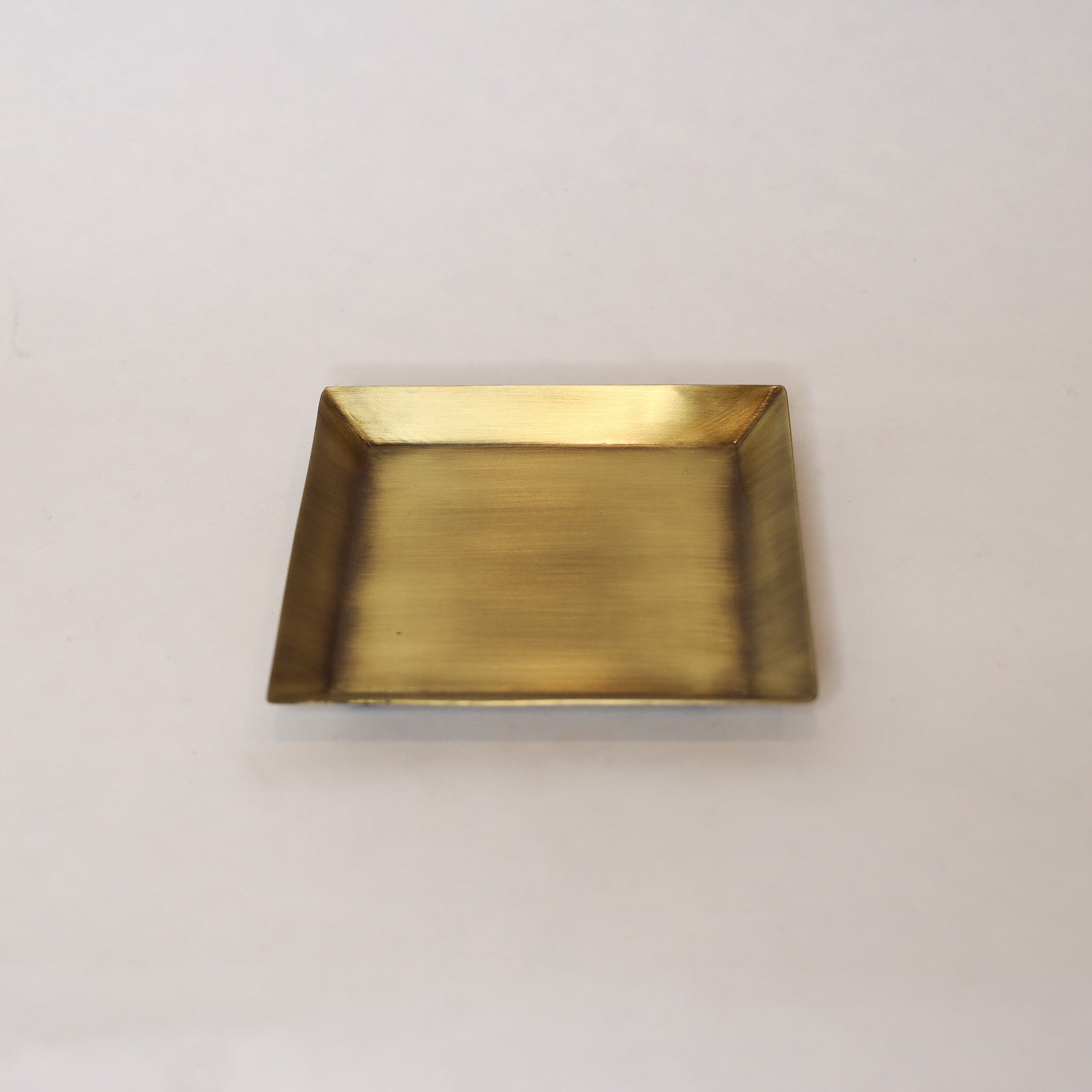 Rectangular brass tray on a light beige background