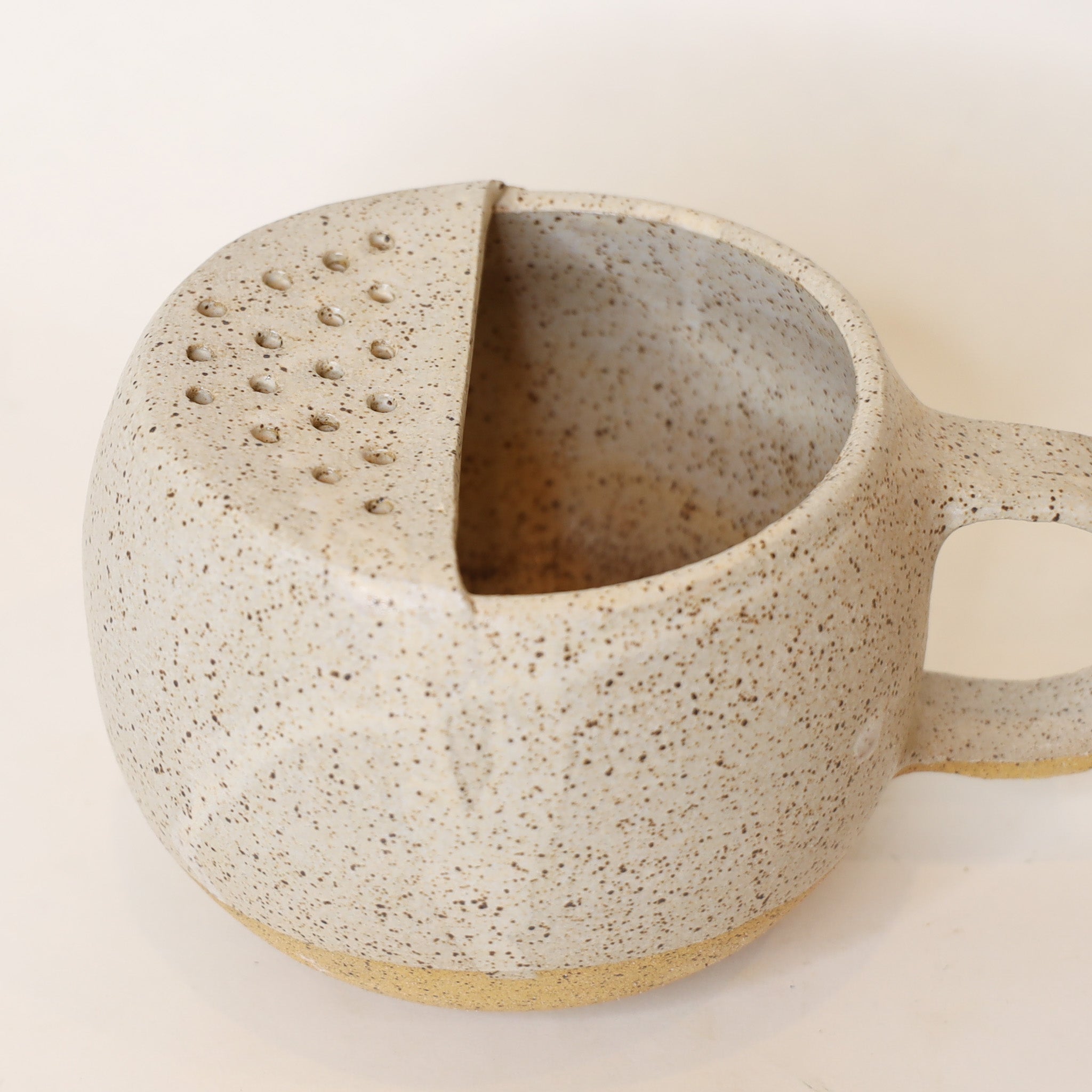 Speckled ceramic mug on a light background