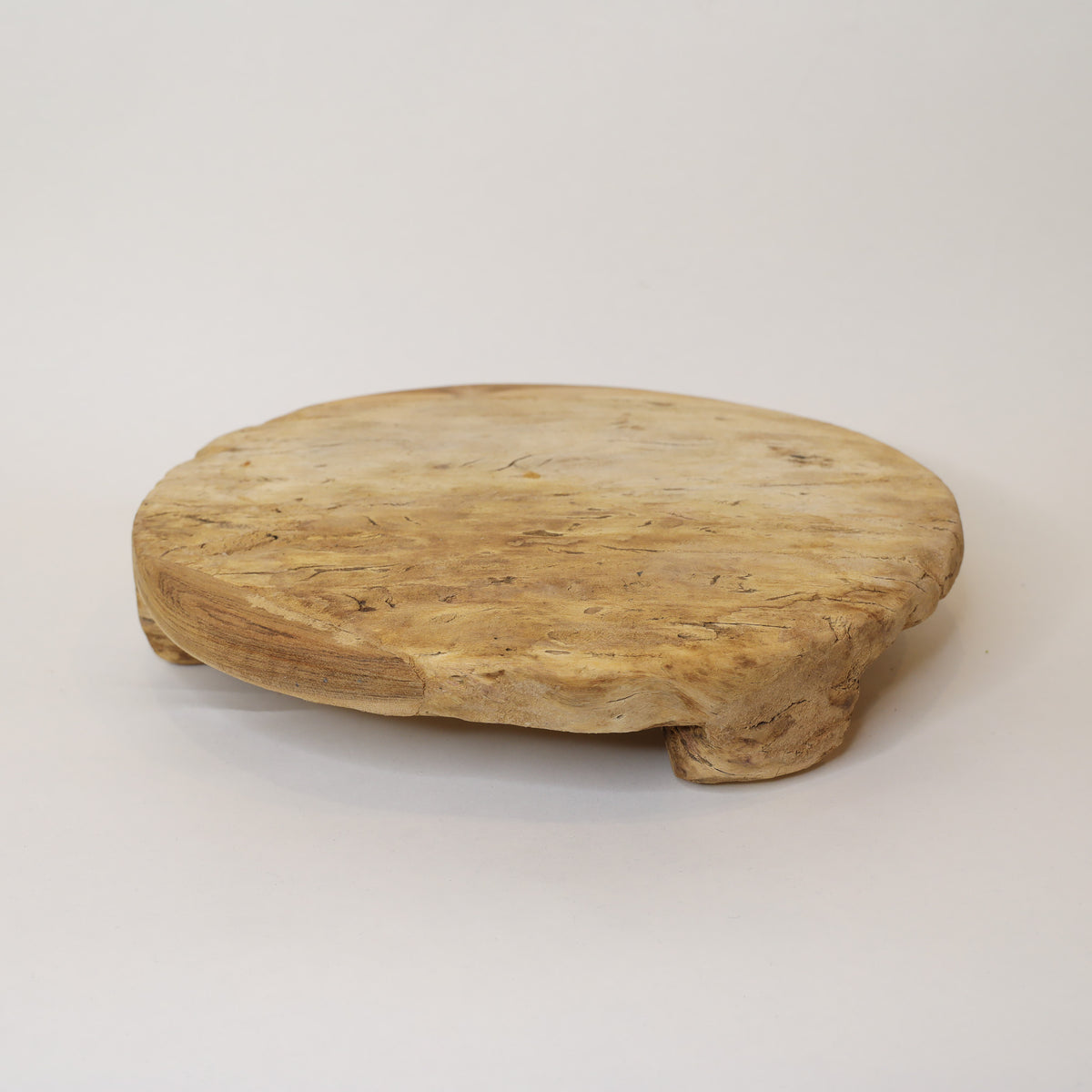 Round wooden tray on a light gray background