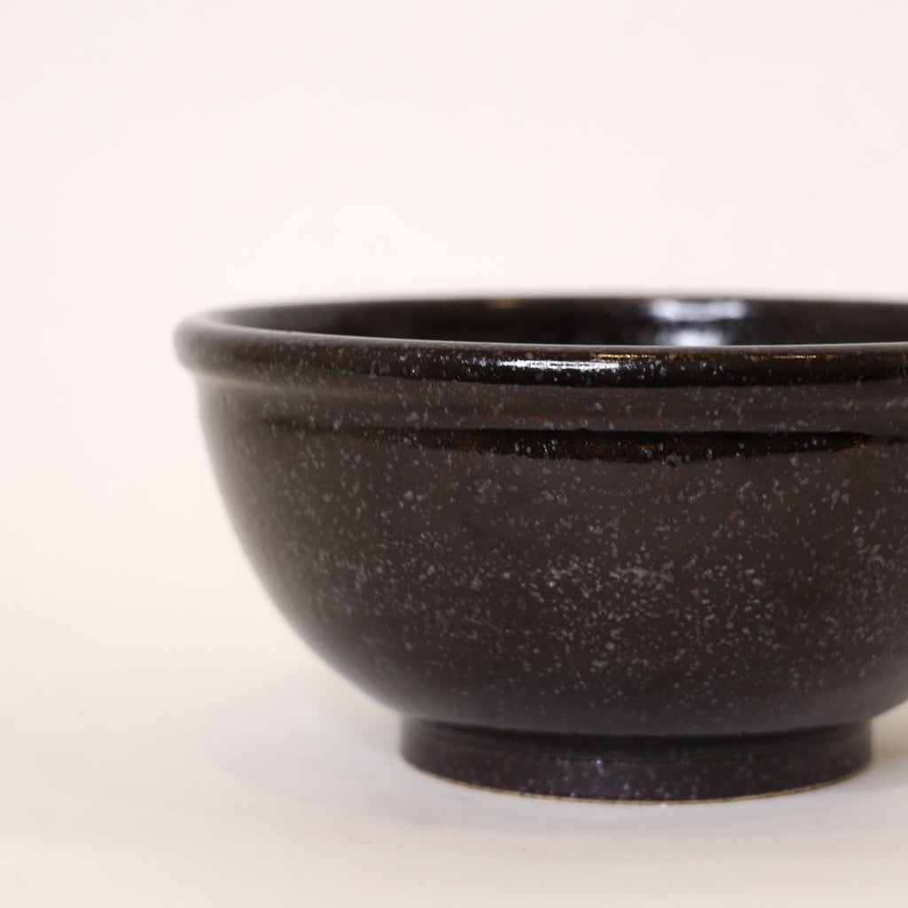 Black ceramic bowl on a white background