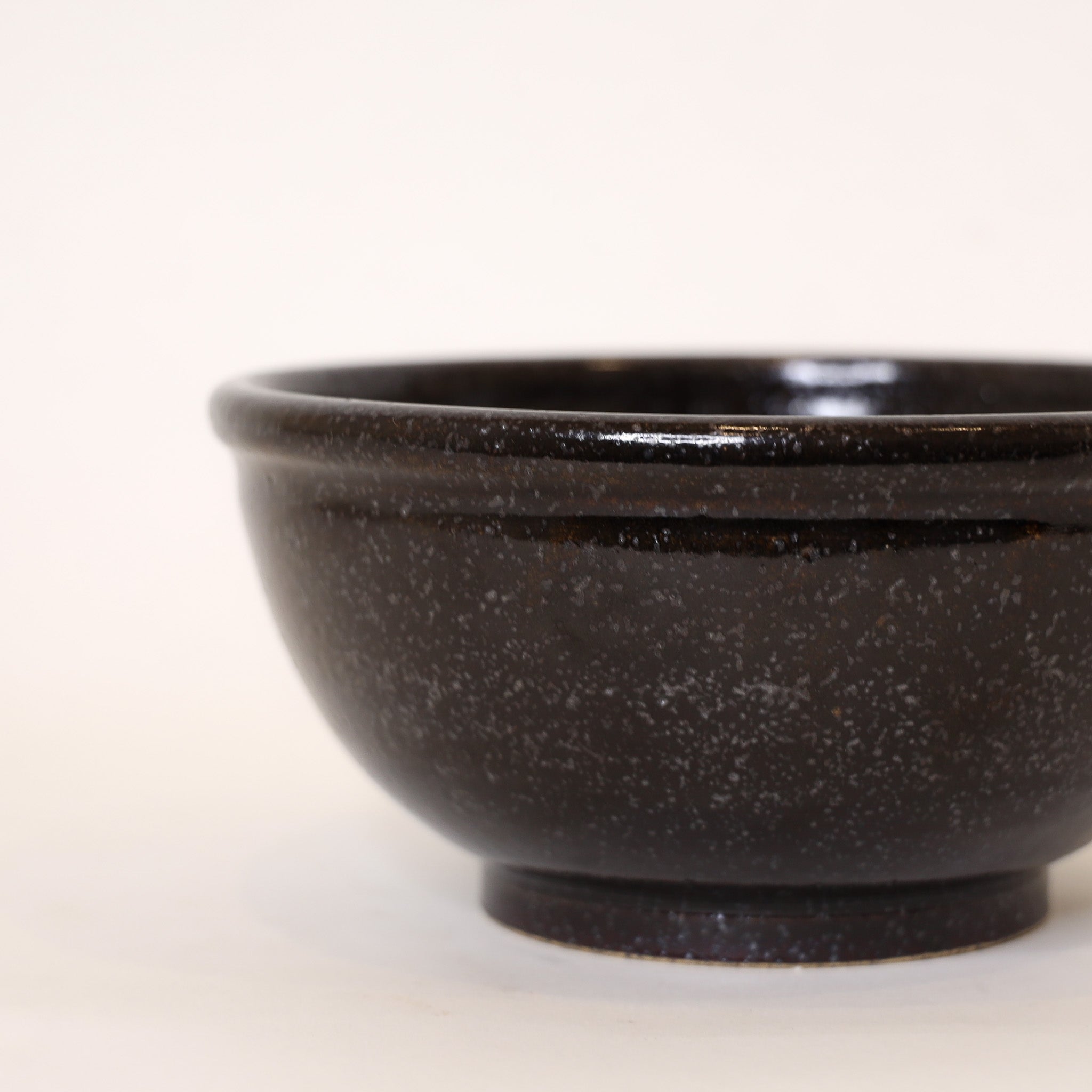 Black ceramic bowl on a white background