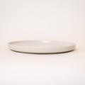 White ceramic plate on a light beige background