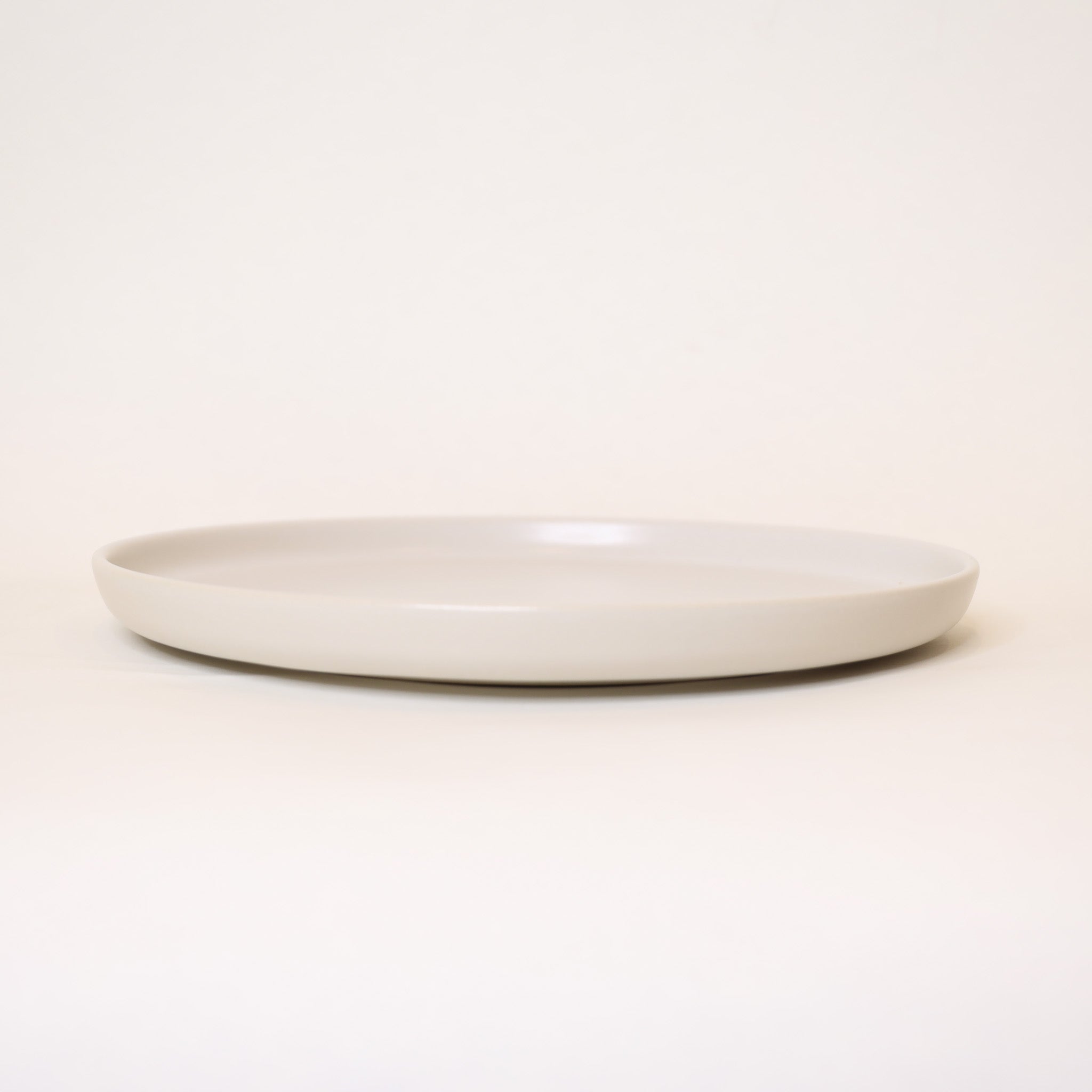 White ceramic plate on a light beige background