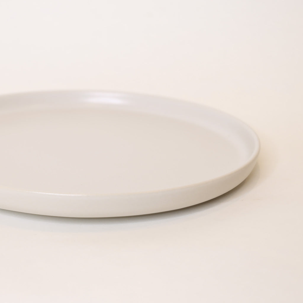 White ceramic plate on a light beige background