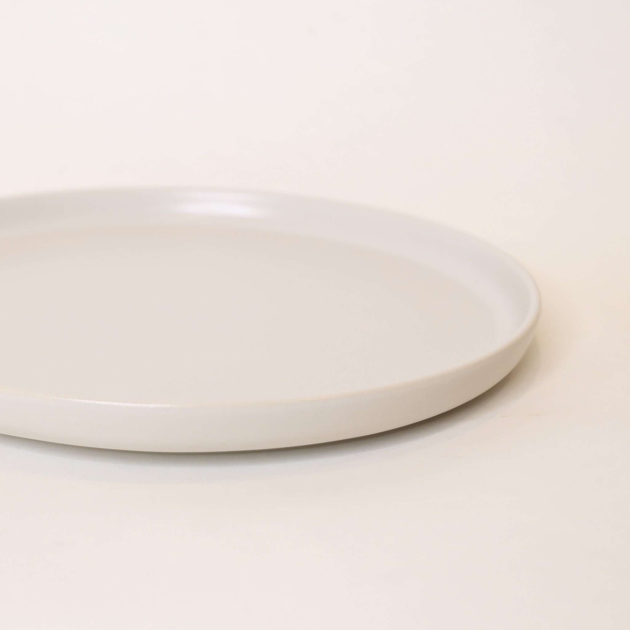 White ceramic plate on a light beige background