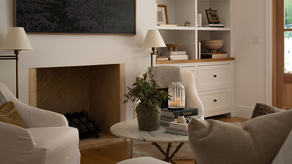 Living room with a fireplace, armchair, and coffee table.