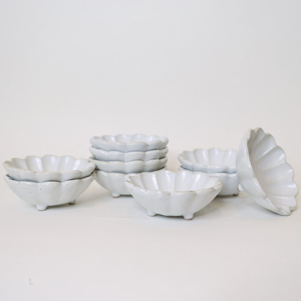 Set of white ceramic bowls on a light gray background