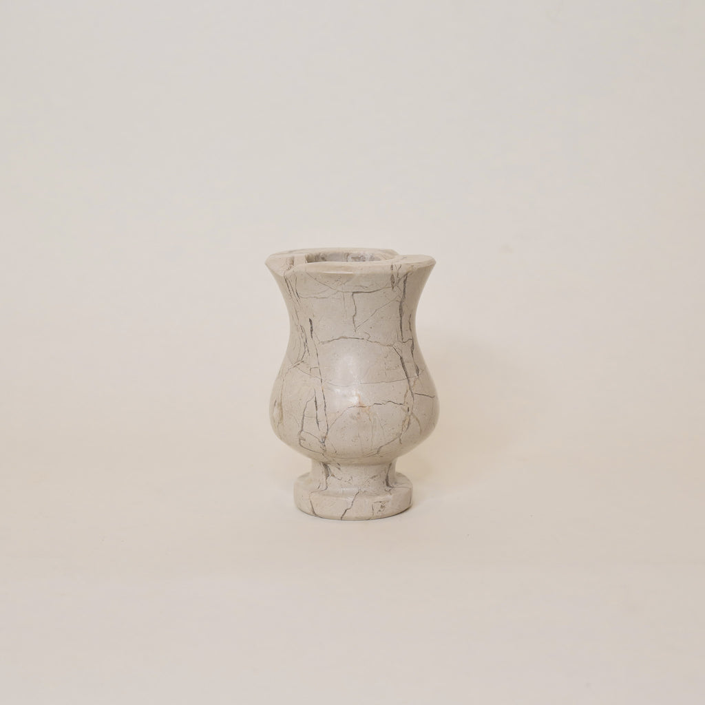 Beige marble vase  on a plain background