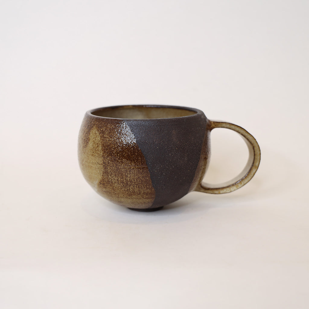 Brown ceramic mug on a white background