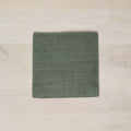 Green fabric square on a beige surface