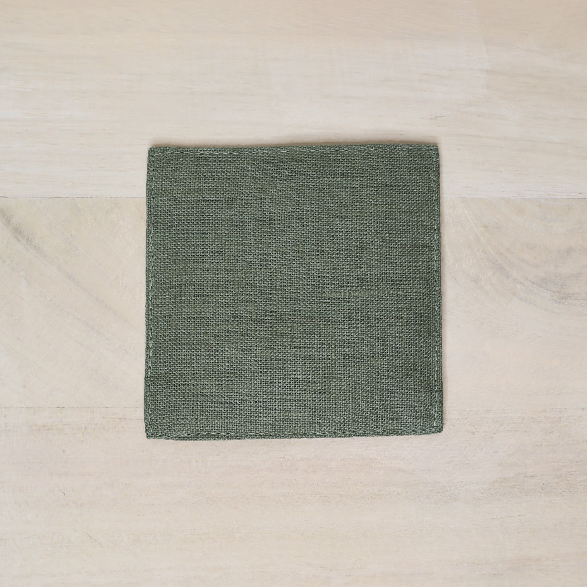 Green fabric square on a beige surface