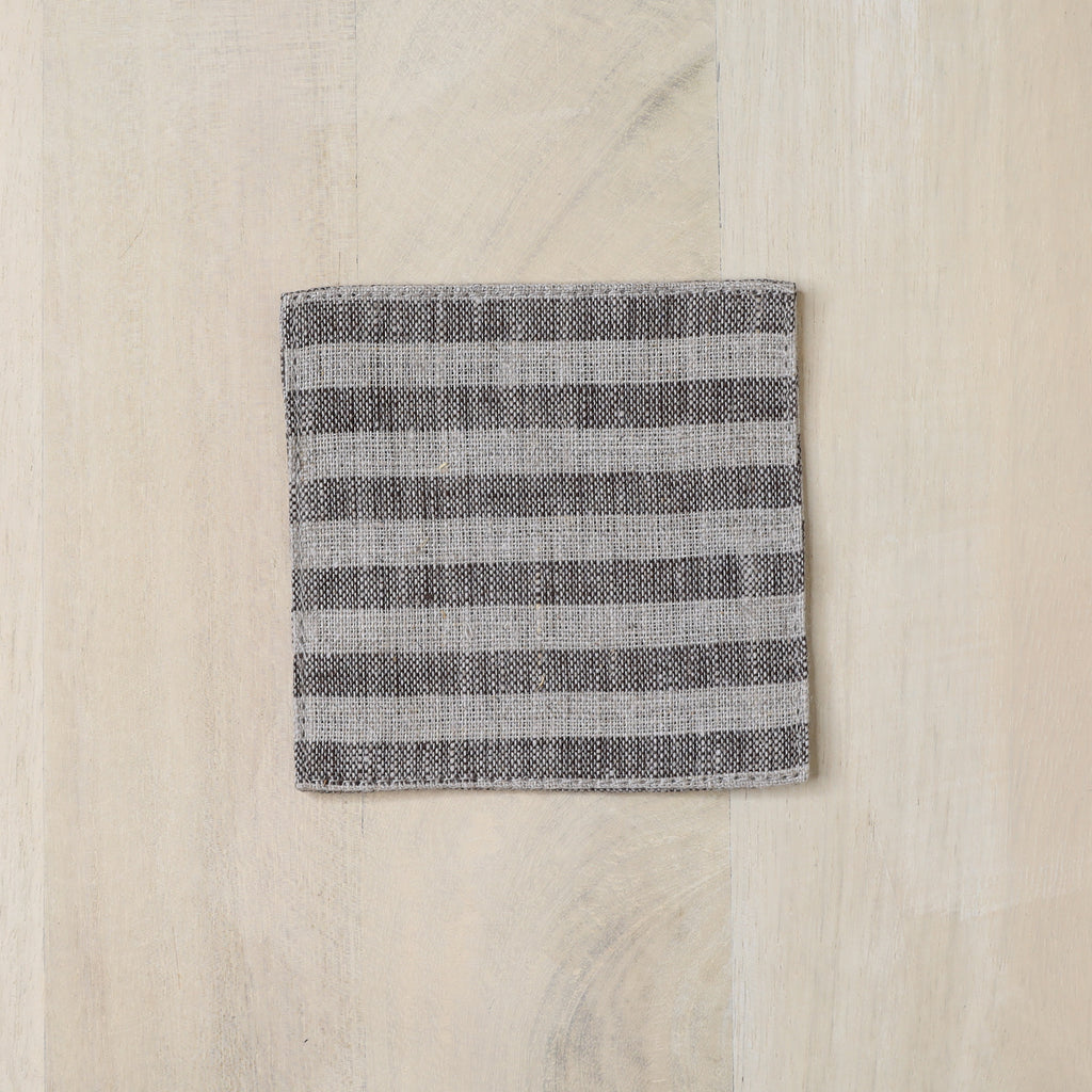 Folded fabric with gray stripes on a wooden surface
