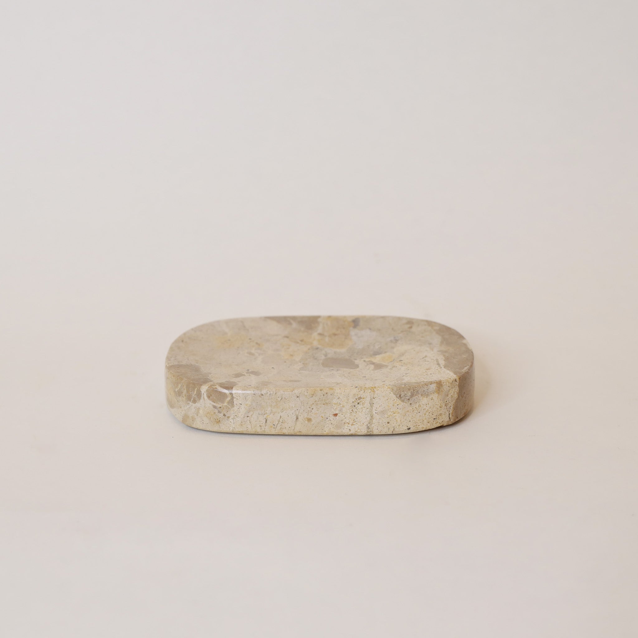 Oval-shaped stone on a beige background