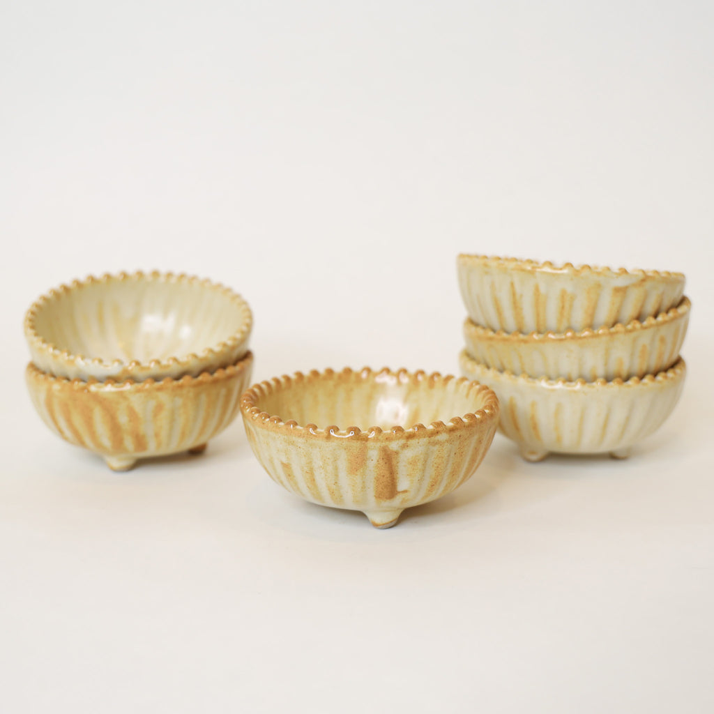Set of ceramic bowls with striped design on a light background