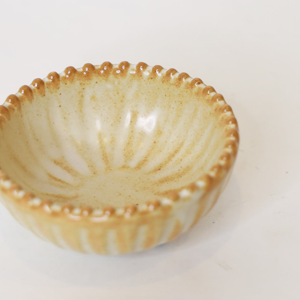 Ceramic bowl with textured rim on a white background