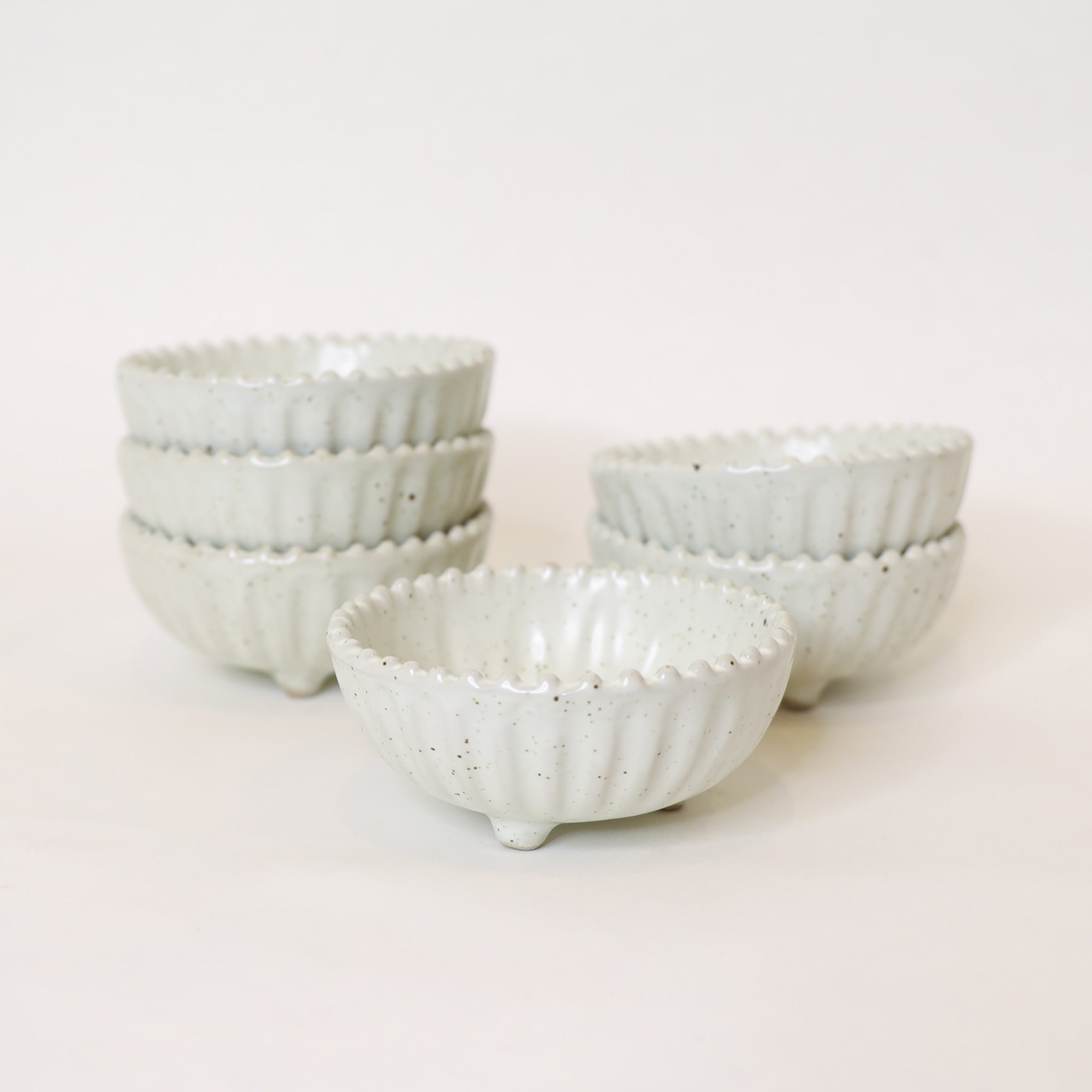 Set of ceramic bowls with textured surface on a light background