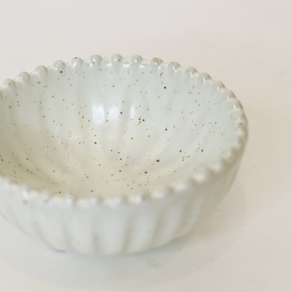 Speckled ceramic bowl on a white background