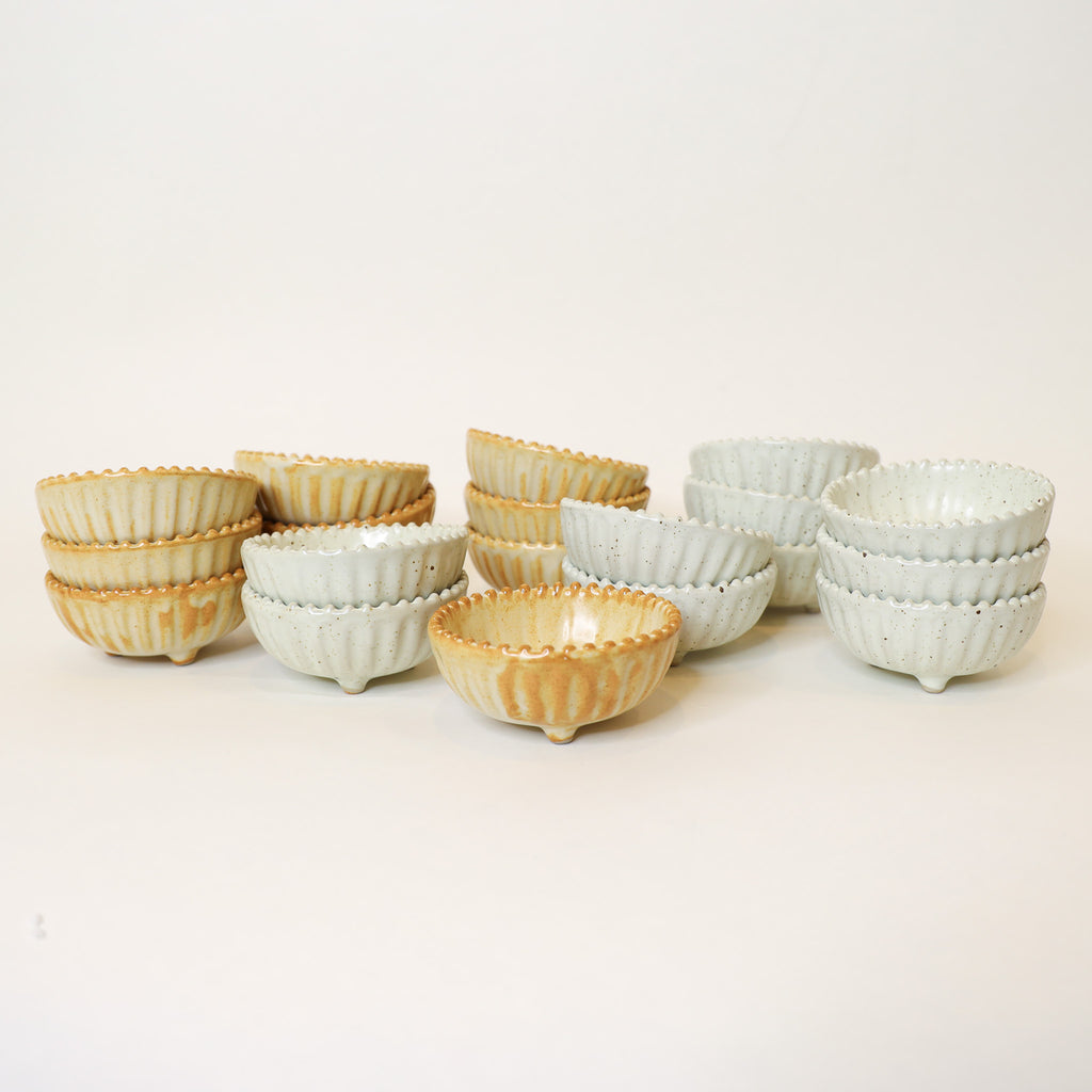 Set of ceramic bowls in various colors on a light background