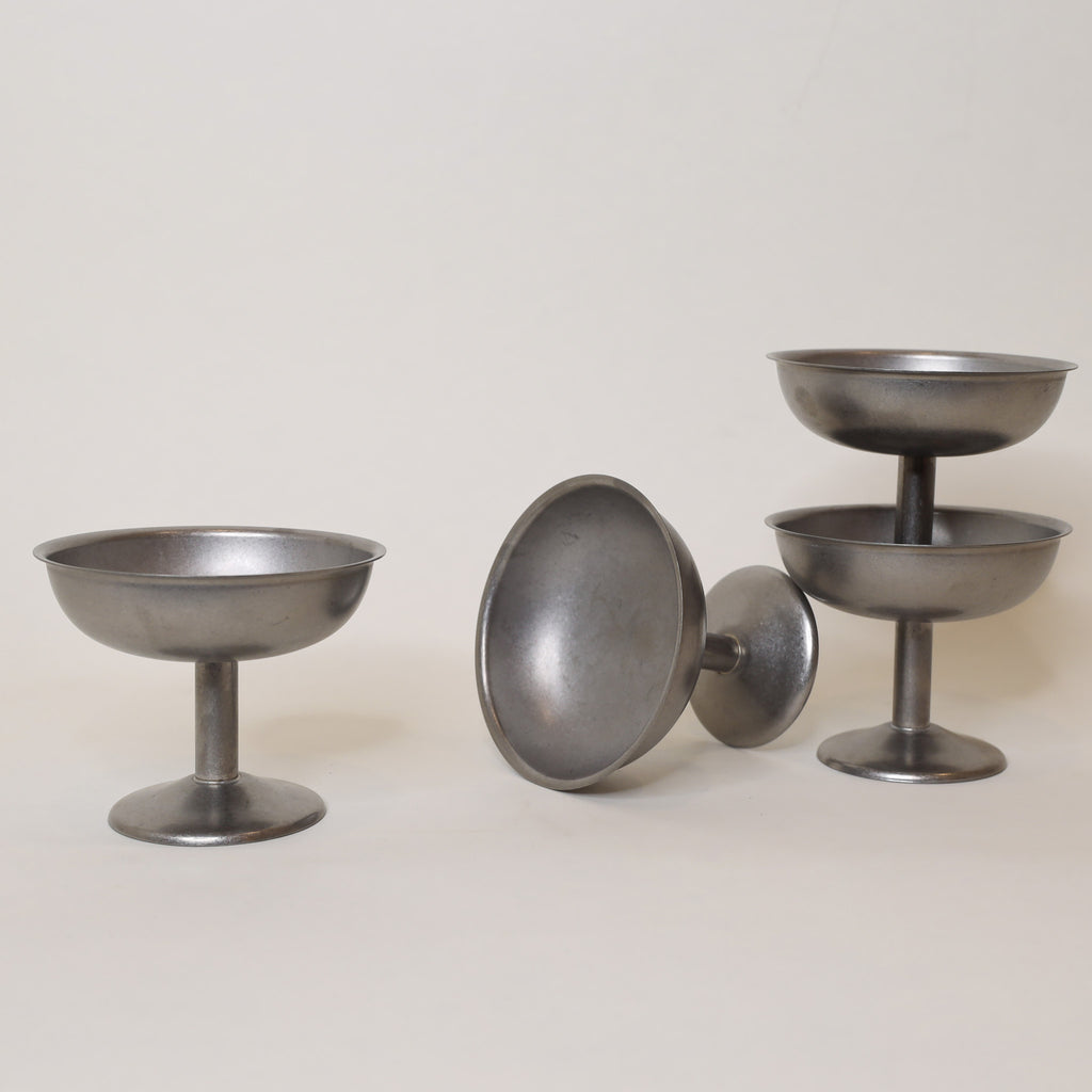 Set of metallic bowls on a light background