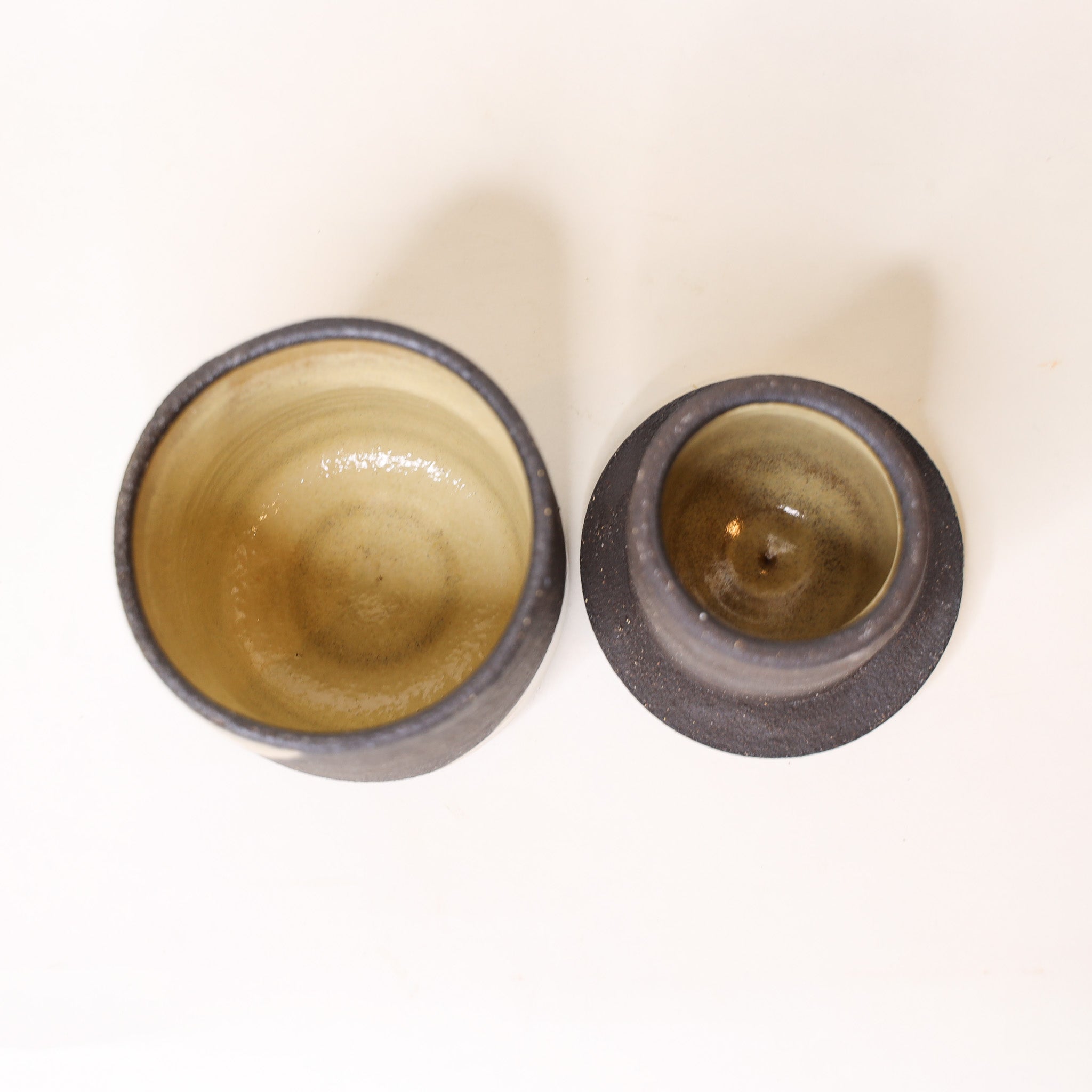 Two ceramic cups with a gradient color on a white background