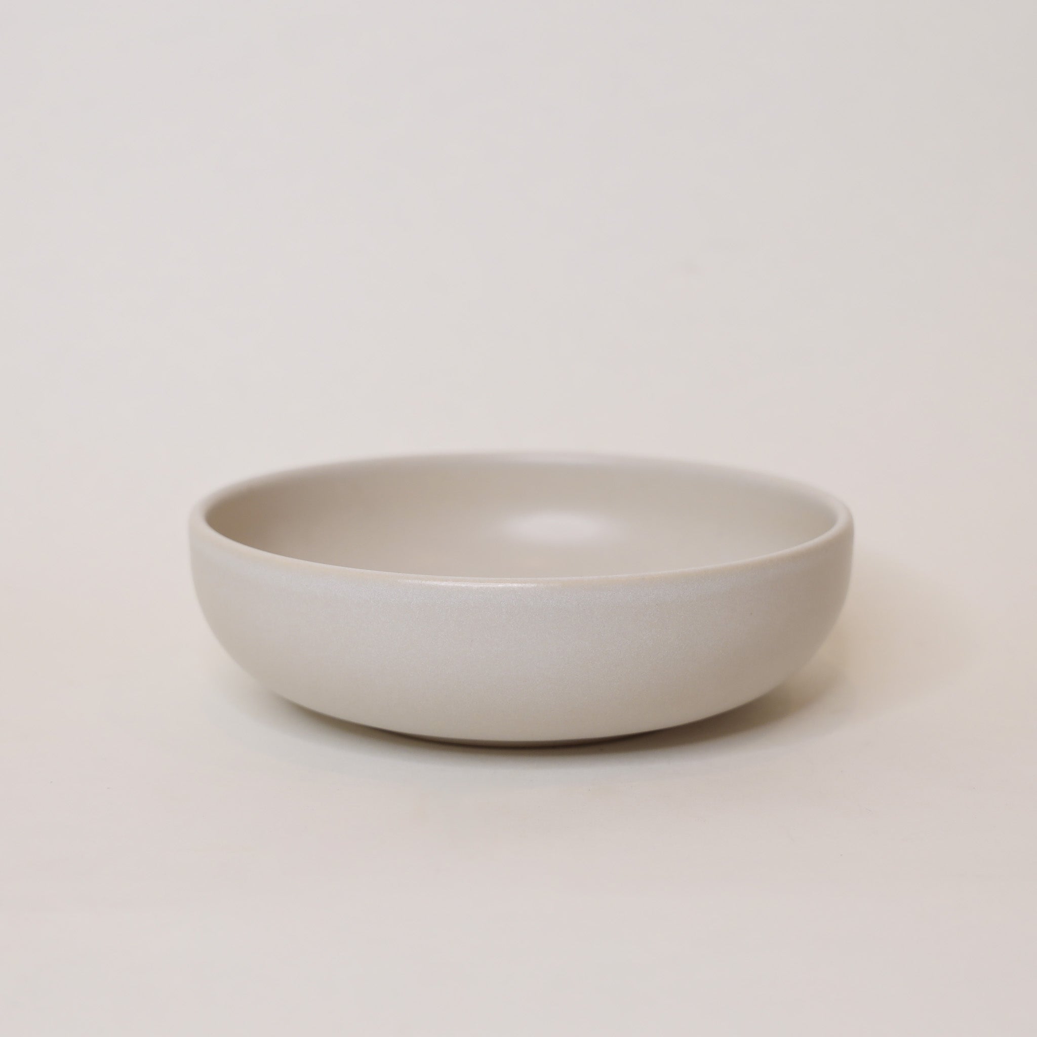White ceramic bowl on a light beige background