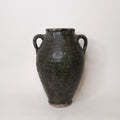 Black ceramic vase with two handles on a white background